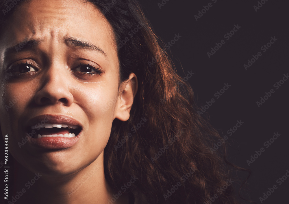 Sad woman, portrait and crying with trauma for abuse, anxiety or mental illness on a dark studio background. Scared, female person or nervous victim with feeling, emotion or afraid in isolation Sad woman, portrait and crying with trauma for abuse, anxiety or mental illness on a dark studio background. Scared, female person or nervous victim with feeling, emotion or afraid in isolation
