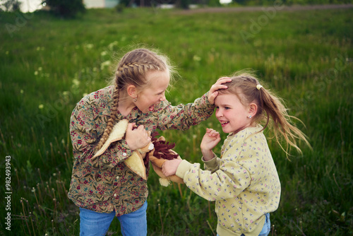 sisters fight over a toy bunny