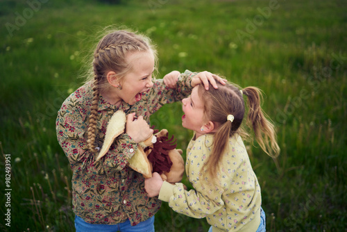 sisters fight over a toy bunny