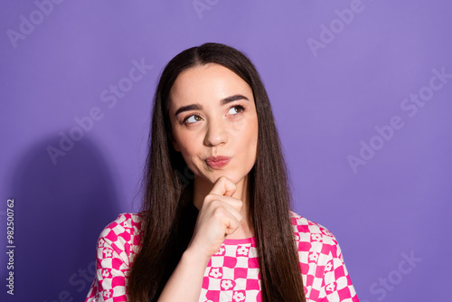 Photo of pretty young woman look empty space ponder wear checkered t-shirt isolated on purple color background