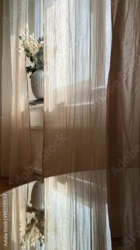 Relaxing flowing curtains in the window vertical