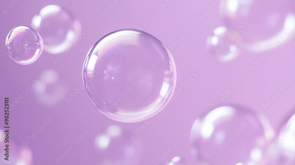 Delicate soap bubbles floating on a pastel violet background. Delicate soap bubbles floating on a pastel violet background.