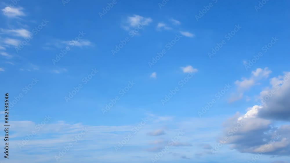 Clear blue sky with scattered white clouds, creating a serene and peaceful atmosphere Clear blue sky with scattered white clouds, creating a serene and peaceful atmosphere