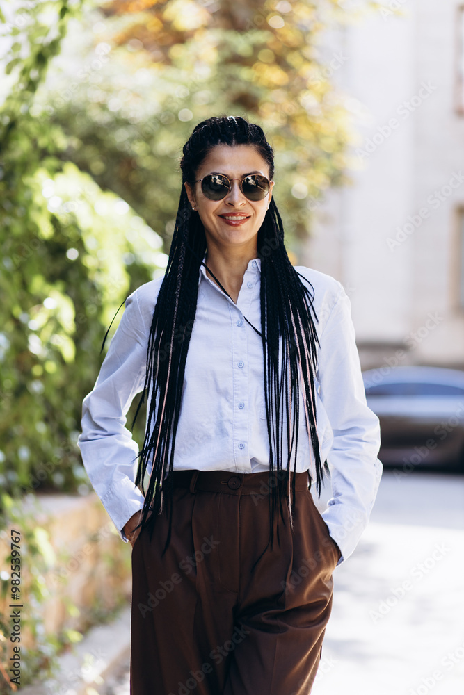 Young woman with braided hair walking in the street Young woman with braided hair walking in the street