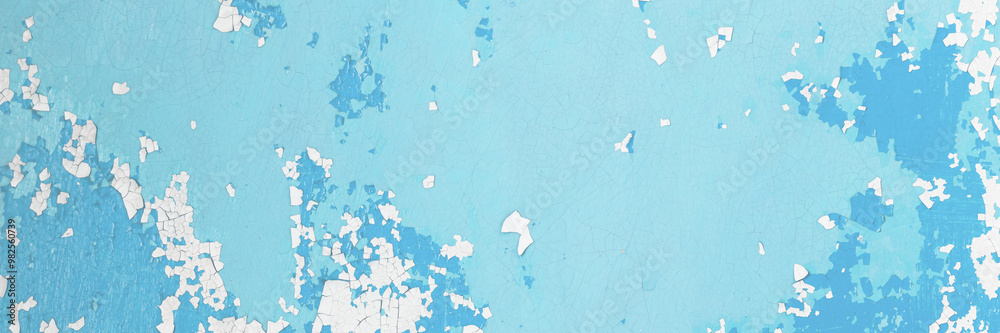 Fototapeta premium Blue peeling paint on the wall. Old concrete wall with cracked flaking paint. Weathered rough painted surface with patterns of cracks and peeling. High resolution texture for background and design.