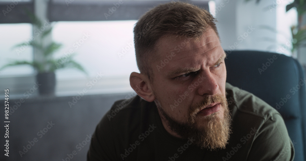 Fototapeta premium Close up of depressed military man with contusion or PTSD crying during rehabilitation after war or counseling session. Soldier talks to psychotherapist or psychologist. Post traumatic stress disorder