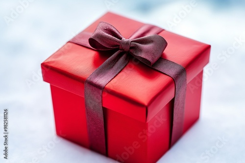 Red gift box with bow on white background.