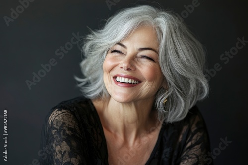 Beautiful gorgeous 50s mid age beautiful elderly senior model woman with grey hair laughing and smiling. Mature old lady close up portrait. Portrait of happy senior woman laughing with generative ai