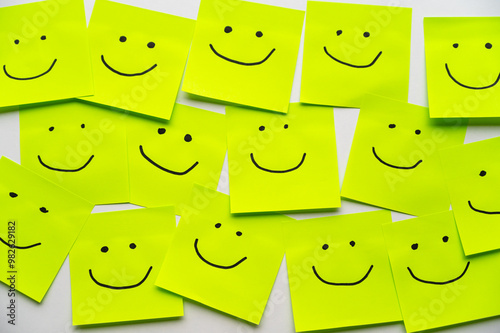 Colored sheets of paper, with smiley faces drawn on them, inclusion, harmony and welcome.