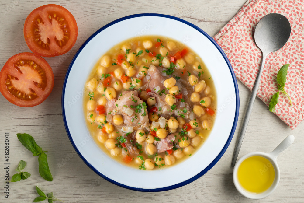 Chickpea stew with pig trotters. Top view table with decorations. Chickpea stew with pig trotters. Top view table with decorations.