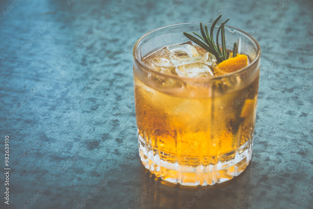 a cocktail made from Whisky, Home-madeInfused Rosemary Syrup, Bitters served in a glass a cocktail made from Whisky, Home-madeInfused Rosemary Syrup, Bitters served in a glass