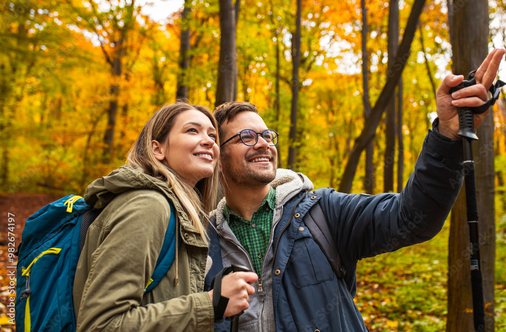 Smiling couple with backpacks hiking together in forest. Smiling couple with backpacks hiking together in forest.