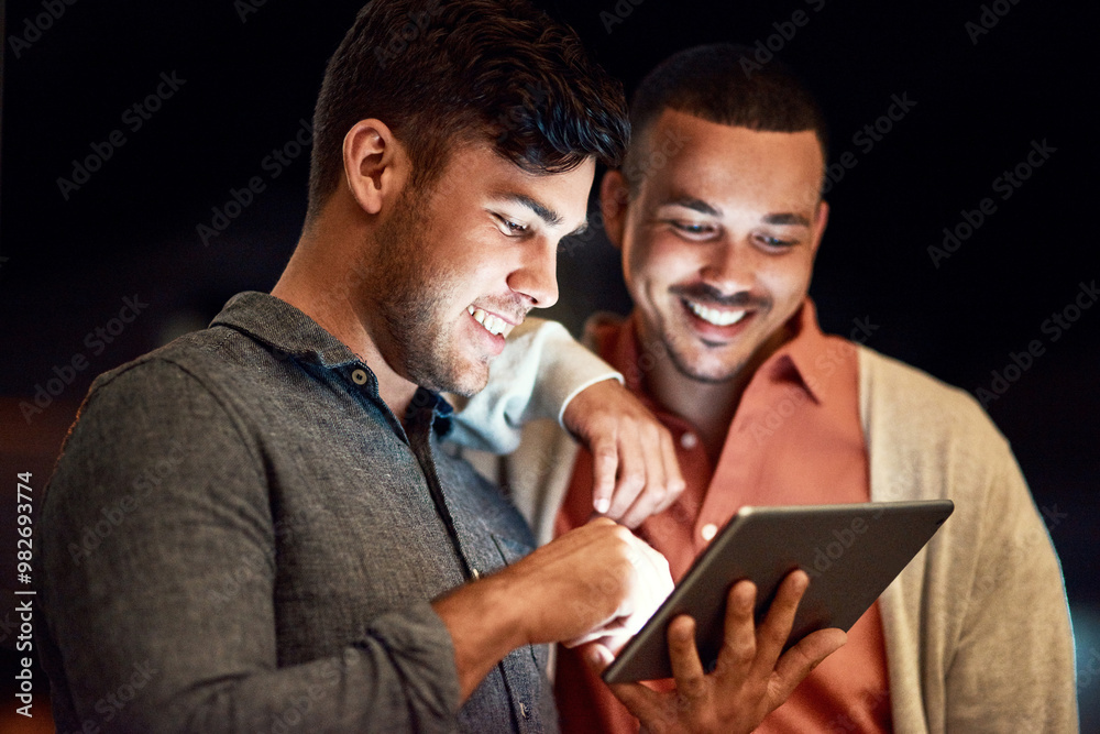 Smile, night and men with tablet, reading and collaboration of typing of novel, digital and office. Dark, author and editing of manuscript, brainstorming and people with ideas and planning with app Smile, night and men with tablet, reading and collaboration of typing of novel, digital and office. Dark, author and editing of manuscript, brainstorming and people with ideas and planning with app