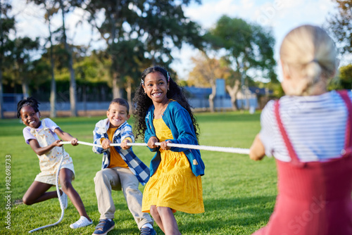 Happy children playing tug of war photo