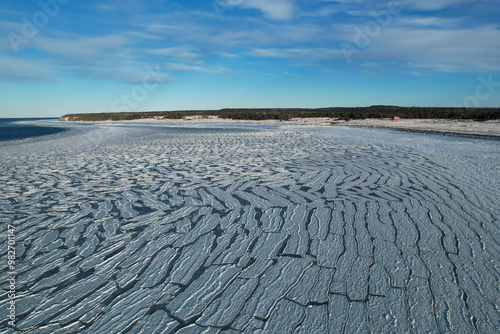 Anticosti Stunning Coastline with Split Ice on the Seawater Surface in Fractal Patterns Seen From Above in the Northern Atlantic Ocean in Winter photo