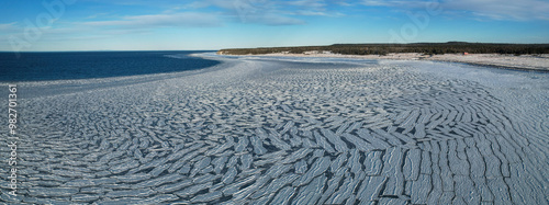 Obraz na płótnie Anticosti Stunning Coastline with Split Ice on the Seawater Surface in Fractal Patterns Seen From Above in the Northern Atlantic Ocean in Winter w salonie