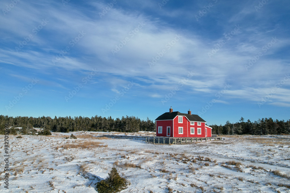 Ancient Refurbished Large Red Canadian House in Sainte-Claire Bay, in the Middle of a Frozen Snow Meadow during Winter, Part of a Old village from the 18th century
