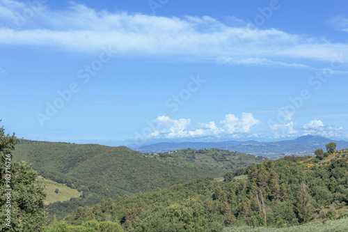 Scenic landscape of central Umbria in Perugia showcasing rolling hills and blue skies during a sunny day photo