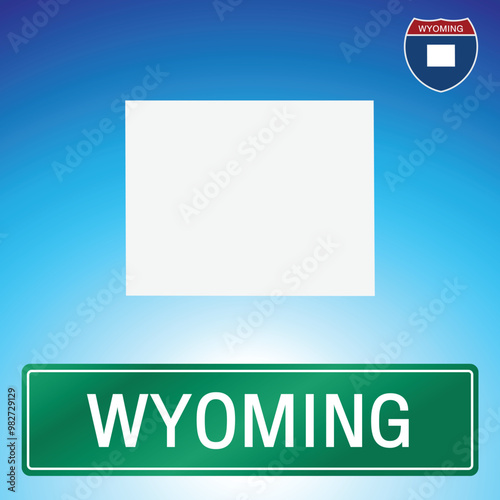 A simple road sign for Wyoming with a map of the state in the background. The sign is green with white lettering, and the map is white with a blue gradient background.