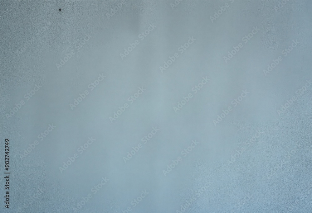 Light Blue Textured Surface with a Small Black Spot Light Blue Textured Surface with a Small Black Spot