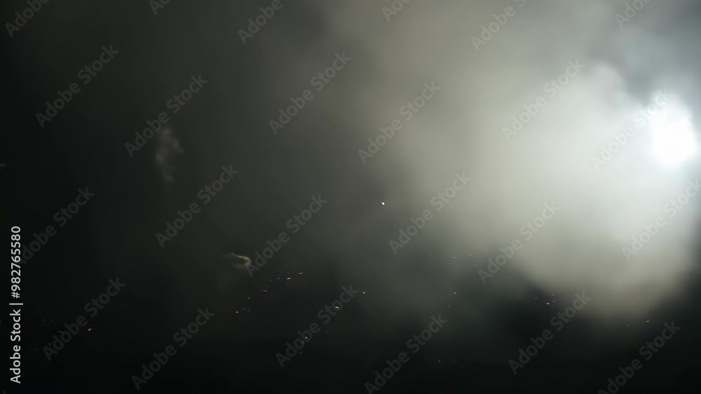 dark scene with a bright flash of light illuminating the surrounding smoke, creating a mysterious and dramatic atmosphere. dark scene with a bright flash of light illuminating the surrounding smoke, creating a mysterious and dramatic atmosphere.