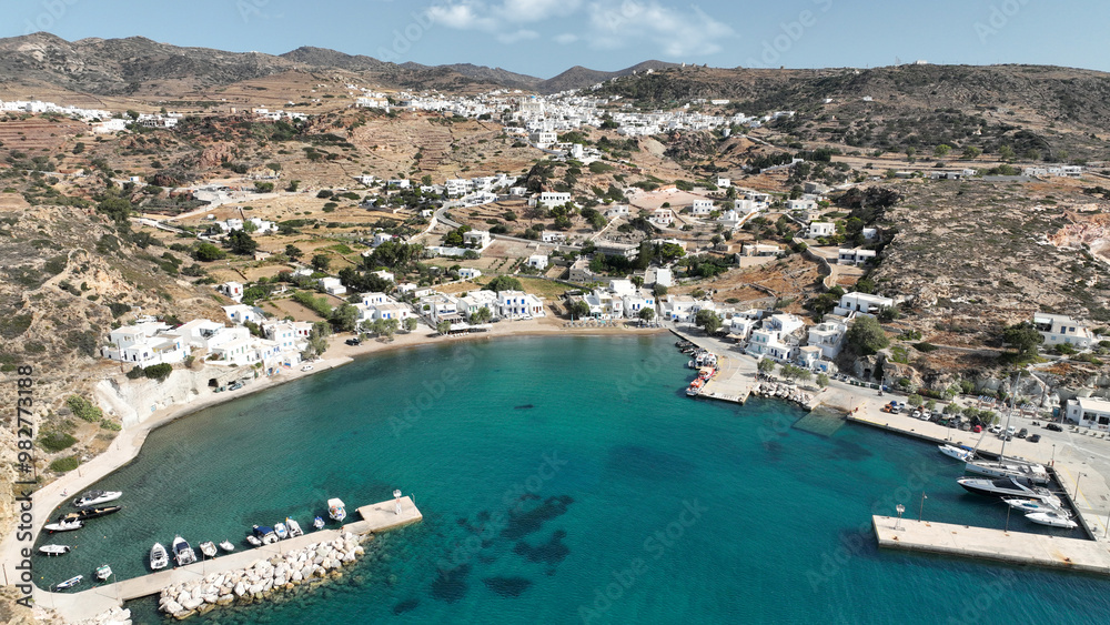 Fototapeta premium Aerial drone photo small port of Psathi untouched by tourism built below picturesque hora of Kimolos island, Cyclades, Greece