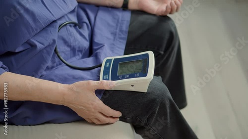 Woman checking blood pressure hypotension diagnostic on medical tonometer	 photo