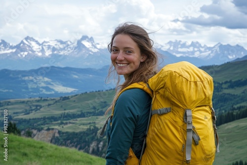 A smiling female traveler with a yellow hiking backpack enjoys the beautiful scenery of the majestic mountains. Travel, adventure. Concept of an active lifestyle, ai