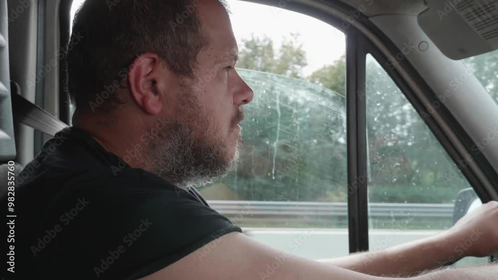 A truck driver with short hair feels extremely tired while driving. His eyes close as he nods off, but he wakes up suddenly before it's too late, narrowly avoiding a disaster. A truck driver with short hair feels extremely tired while driving. His eyes close as he nods off, but he wakes up suddenly before it's too late, narrowly avoiding a disaster.