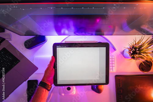 Designer holding graphic tablet project. Home studio equipment laptop monitor glow neon light. photo