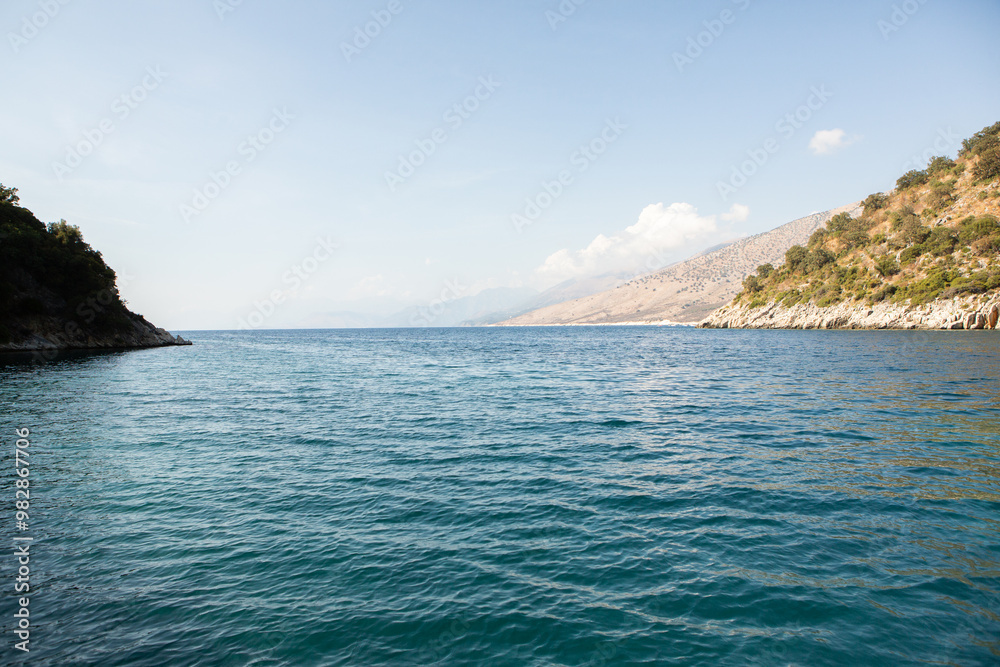Very beautiful coastline on the Ionian Sea in Albania. The beach with fine sand in the mountains of Albania. Vacation at the sea. Very beautiful coastline on the Ionian Sea in Albania. The beach with fine sand in the mountains of Albania. Vacation at the sea.