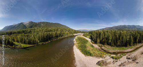 Panoramic View of Serene River and Lush Forest in British Columbia, Canada with Majestic Mountains