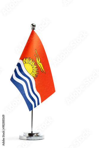 Table national flag Kiribati on metal flagpole on white background. photo