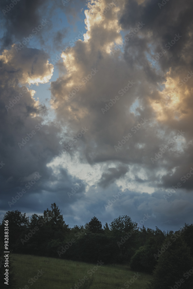 Fototapeta premium sunset over the field in summer with dramatic sky in Czech Republic, rural view