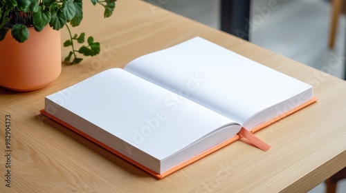 Blank Open Book on Wooden Table with Green Plant