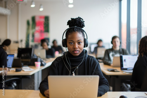 A black woman customer service working with a headset. A team behind her, all engaged in solving customer issues.