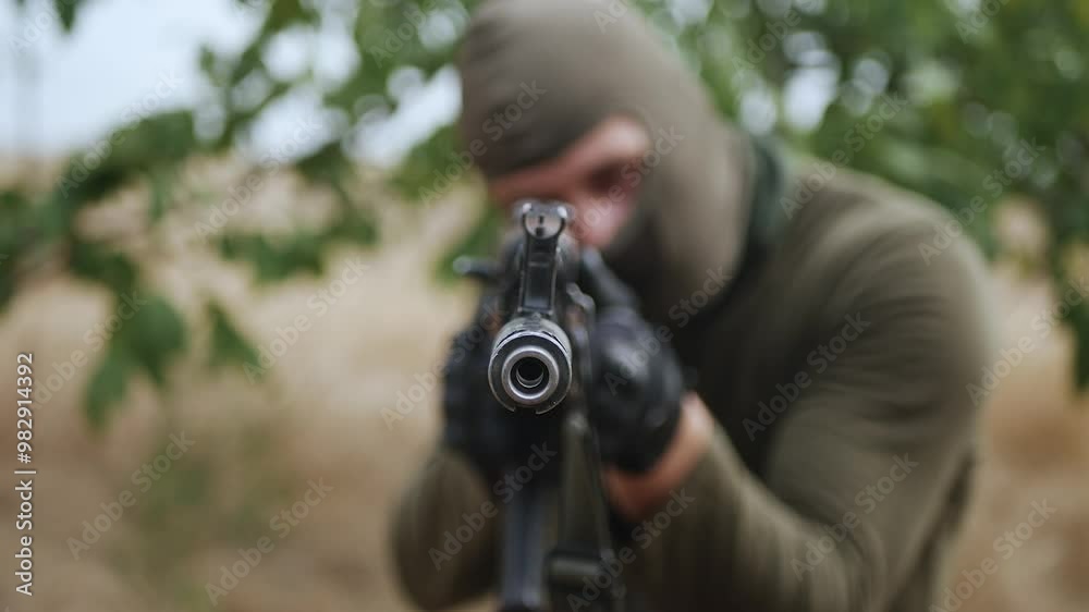 A professional soldier aims his machine gun at the enemy. A professional soldier aims his machine gun at the enemy.