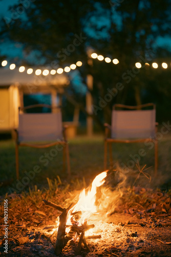 Summer Campfire Nights, Experience the Adventure of Balefire Flames in Forest, Enjoying Hot Food and Cozy Evenings at Campground, Wood Burns Brightly Under the Stars, Creating Unforgettable Vacation photo