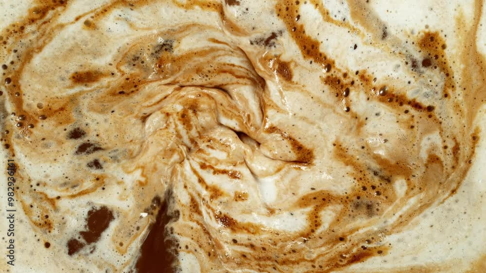 Super Slow Motion Detail Shot of Coffee Foam Swirling . Filmed on High Speed Cinematic Camera at 1000 FPS . Super Slow Motion Detail Shot of Coffee Foam Swirling . Filmed on High Speed Cinematic Camera at 1000 FPS .