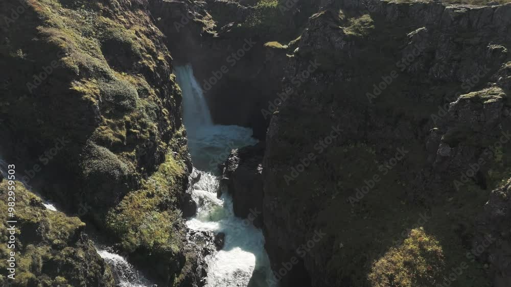 A Dramatic Aerial View Of An Icelandic Canyon, Highlighting The Mountain River That Cuts Through The Rugged Terrain, Surrounded By Cliffs And Rocks. A Dramatic Aerial View Of An Icelandic Canyon, Highlighting The Mountain River That Cuts Through The Rugged Terrain, Surrounded By Cliffs And Rocks.
