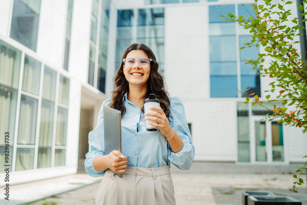 Young successful woman is going to work at modern business building