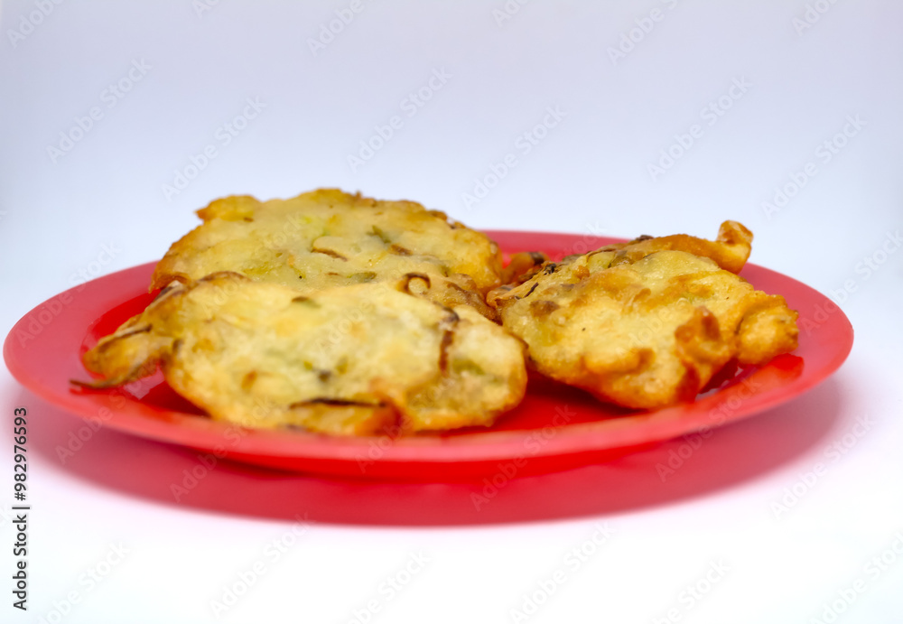 fried bakwan food served on a red plate