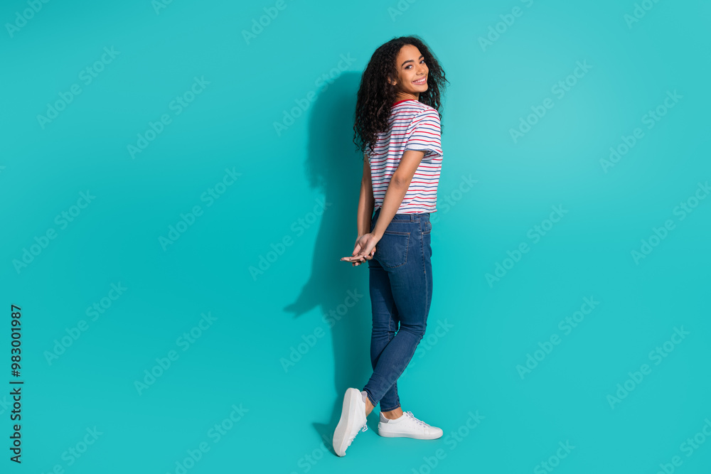 Full body photo of attractive young woman turn around cute posing dressed stylish striped clothes isolated on aquamarine color background Full body photo of attractive young woman turn around cute posing dressed stylish striped clothes isolated on aquamarine color background