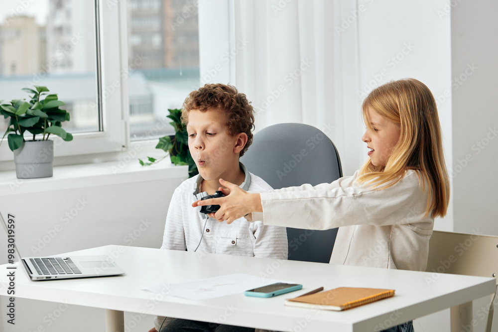Girl and Boy Engaged in Education Two siblings, a girl and a boy, sit happily in their cozy living room, surrounded by educational tools The girl wears headphones, immersed in an online learning Girl and Boy Engaged in Education Two siblings, a girl and a boy, sit happily in their cozy living room, surrounded by educational tools The girl wears headphones, immersed in an online learning