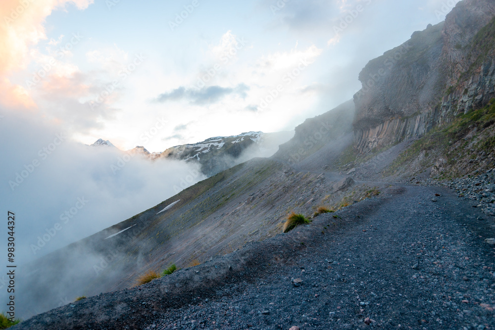 A dangerous mountain trail in the fog on the cliff side. The North Caucasus. Russia
