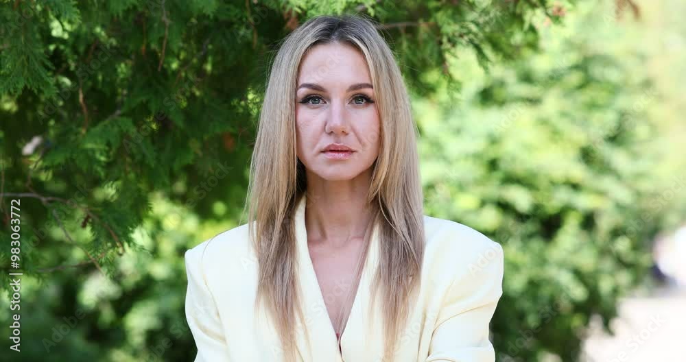 Beautiful middle aged woman posing in a summer park Beautiful middle aged woman posing in a summer park