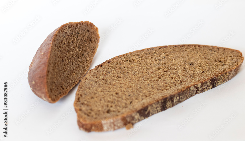 Close up shot of pieces of brown bread on white background. Food Close up shot of pieces of brown bread on white background. Food