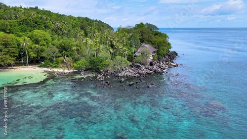 Beachfront Bungalow Overlooking an Emerald Green Sea on a Tropical Island