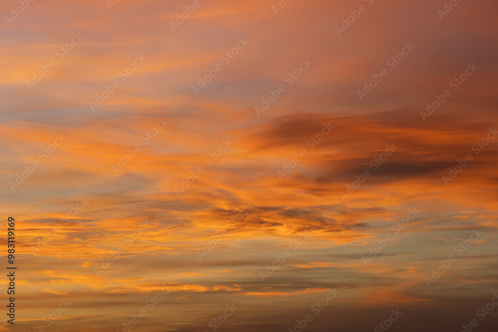 Beautiful and intense orange clouds filling the sky during a breathtaking sunset, creating a captivating natural spectacle Beautiful and intense orange clouds filling the sky during a breathtaking sunset, creating a captivating natural spectacle