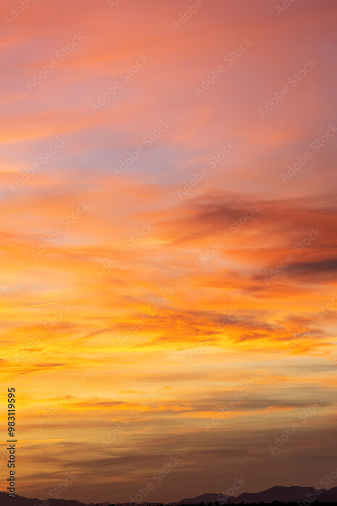 Stunning sunset sky filled with warm hues of orange, pink, and purple, creating a colorful and vibrant nature scene. Perfect for projects needing a touch of beauty